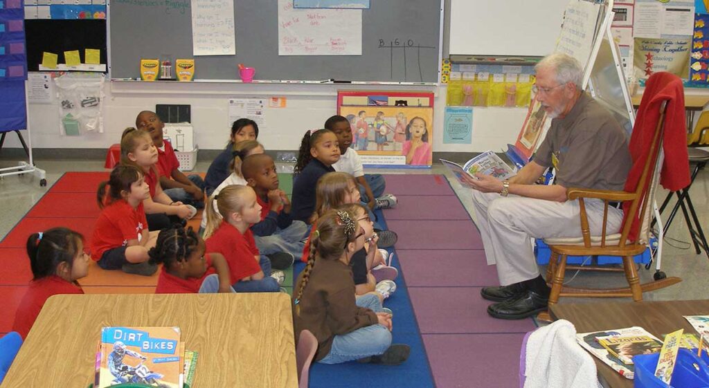 Volunteer reading to students